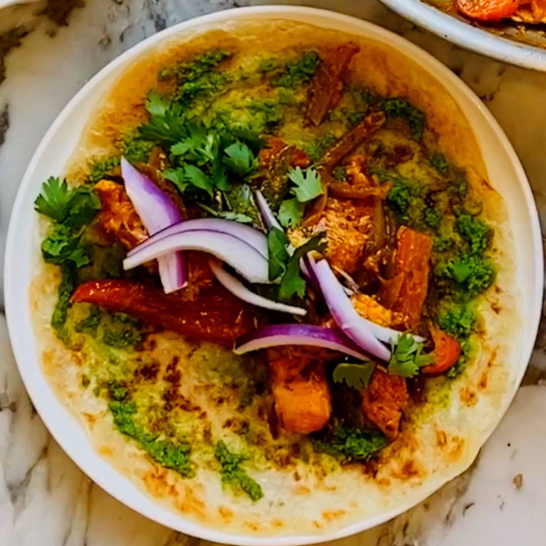 paratha with chutney, chicken filling, topped with thinly sliced onions.