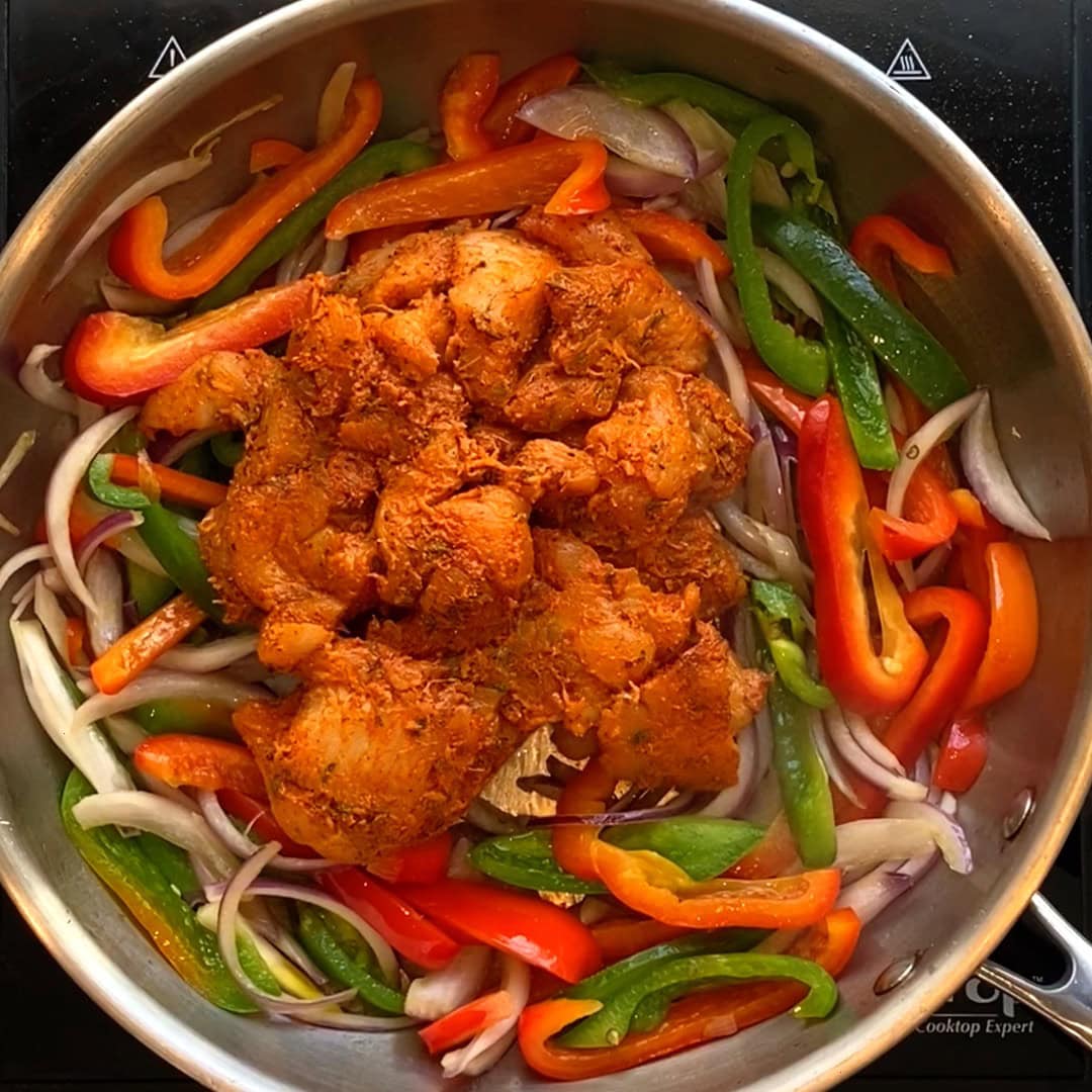 marinated chicken added to sauteed peppers.