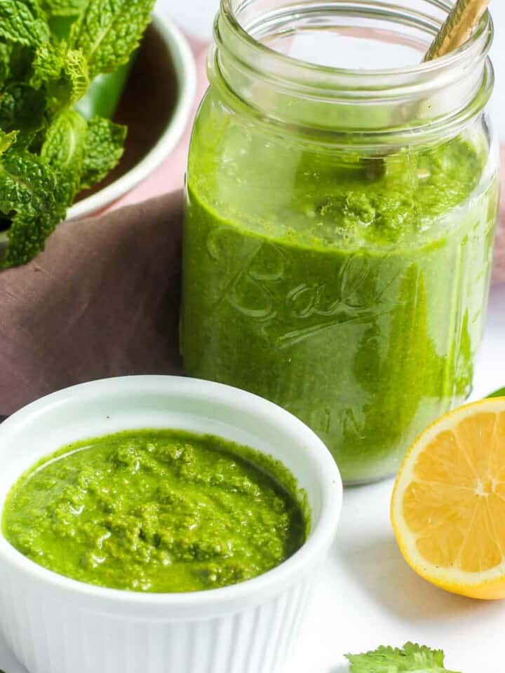cilantro mint chutney in a bowl and glass jar