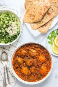 dum aloo served with parathas and cucumber salad