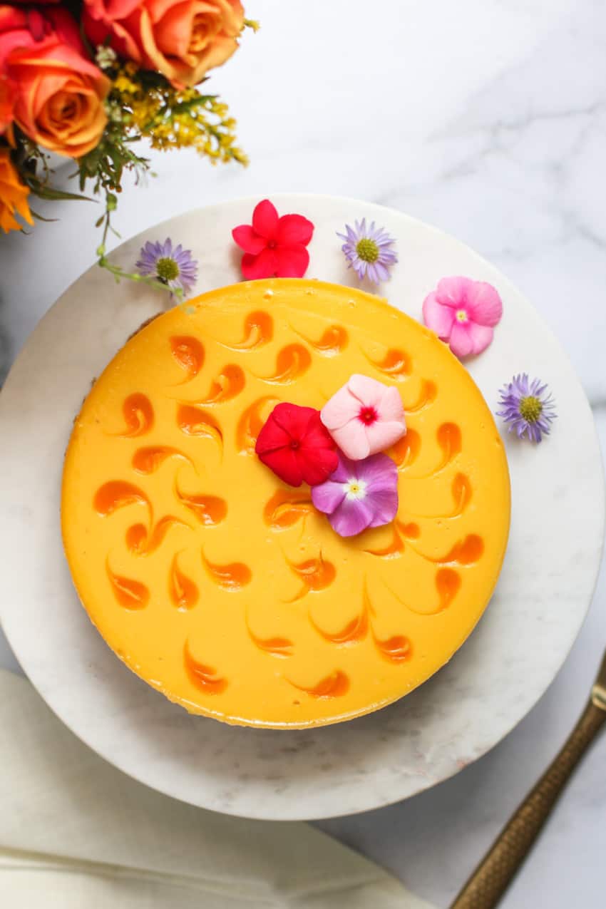 Mango cheese cake on a marble cake stand  