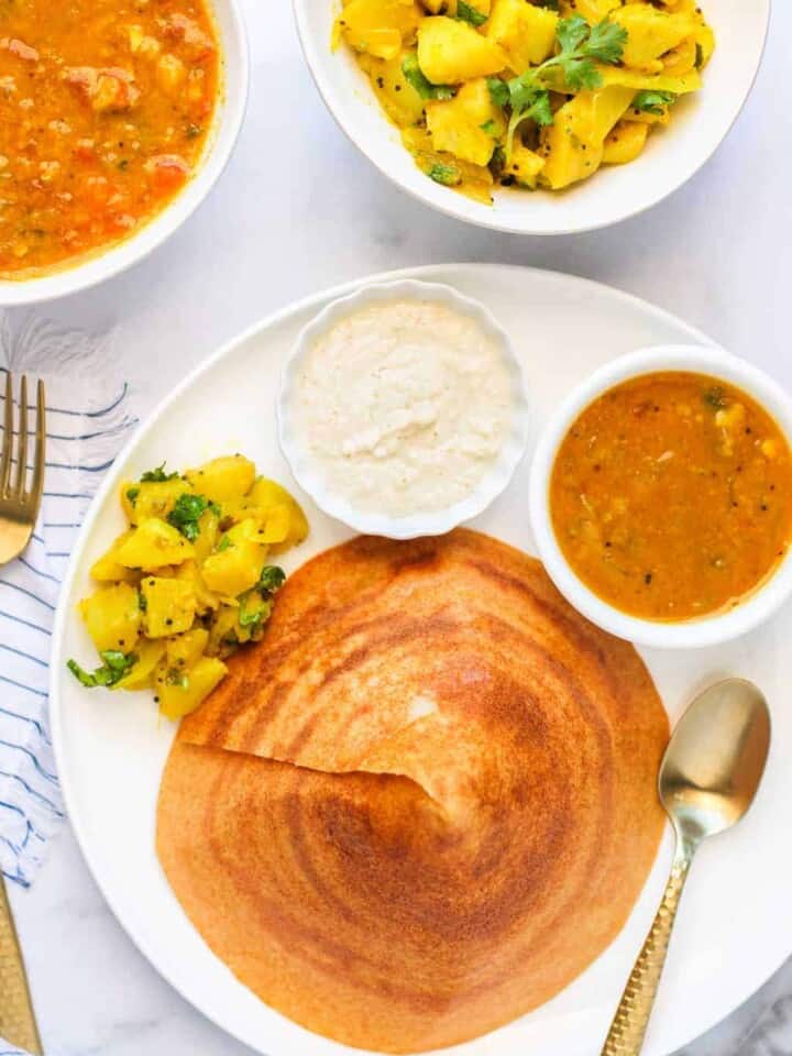 quinoa dosa served with chutney, potatoes and sambar
