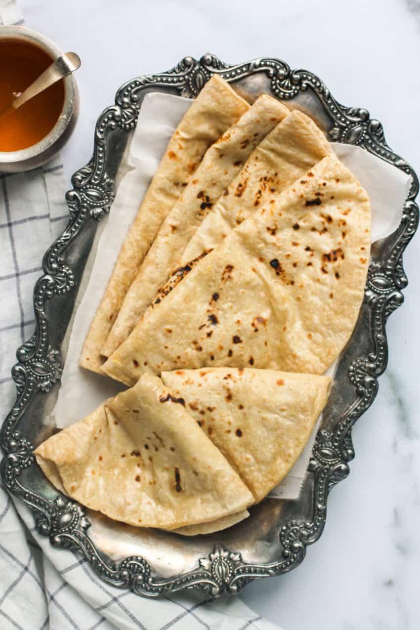 Making roti (Indian Chapati) on roti tawa made of wheat with hand