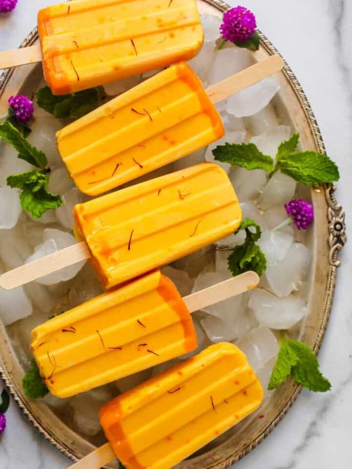 mango ice pops in a silver tray