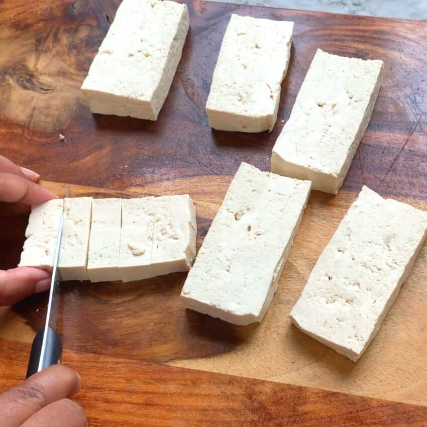 cutting tofu into smaller cubes 