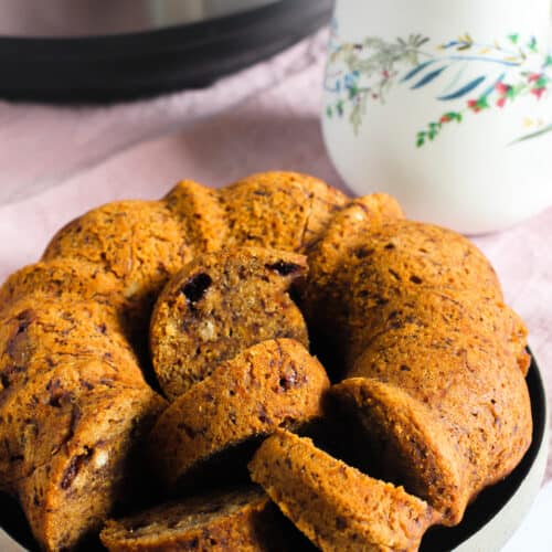 banana bread in a plate next to a cup of tea and Instant Pot a