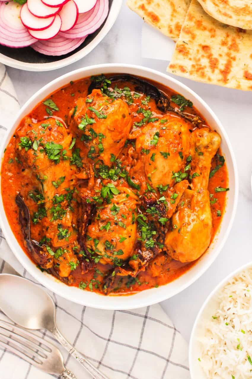 Achari Chicken served with naan and rice 
