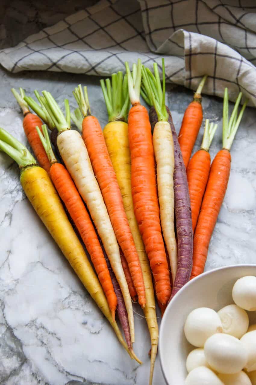 fresh carrots and pearl onions in bowl