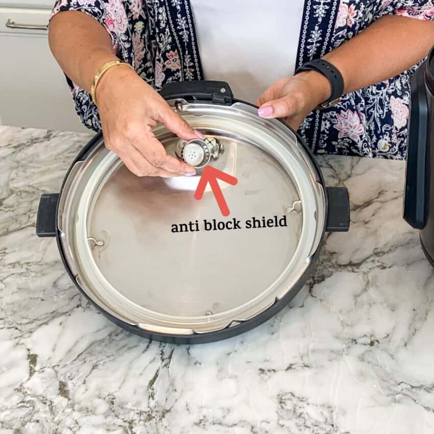 photo showing how to secure the anti block shield on the Instant Pot lid. 