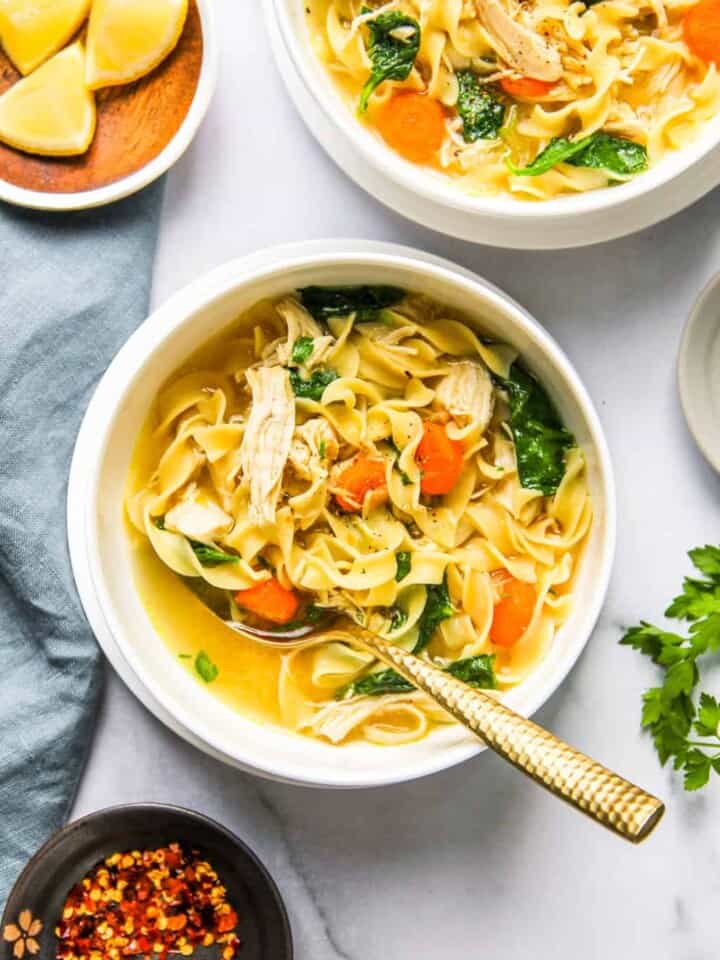 2 bowls of chicken noodle soup with kale