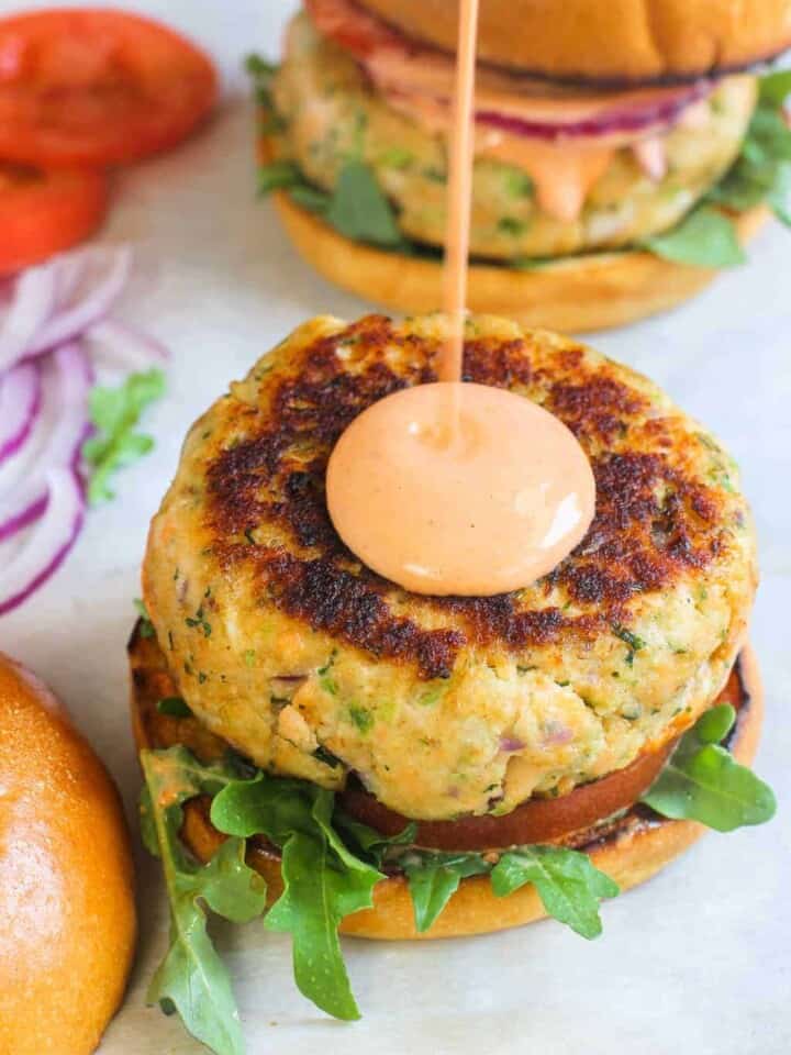salmon burger with drizzle of sriracha mayo