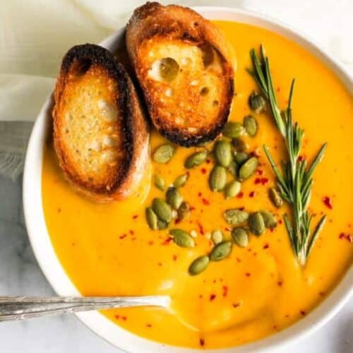 butternut squash soup served in a white bowl