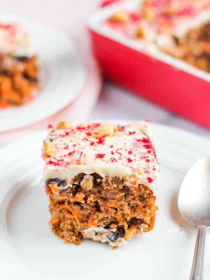 carrot cake with frosting served in a white plate