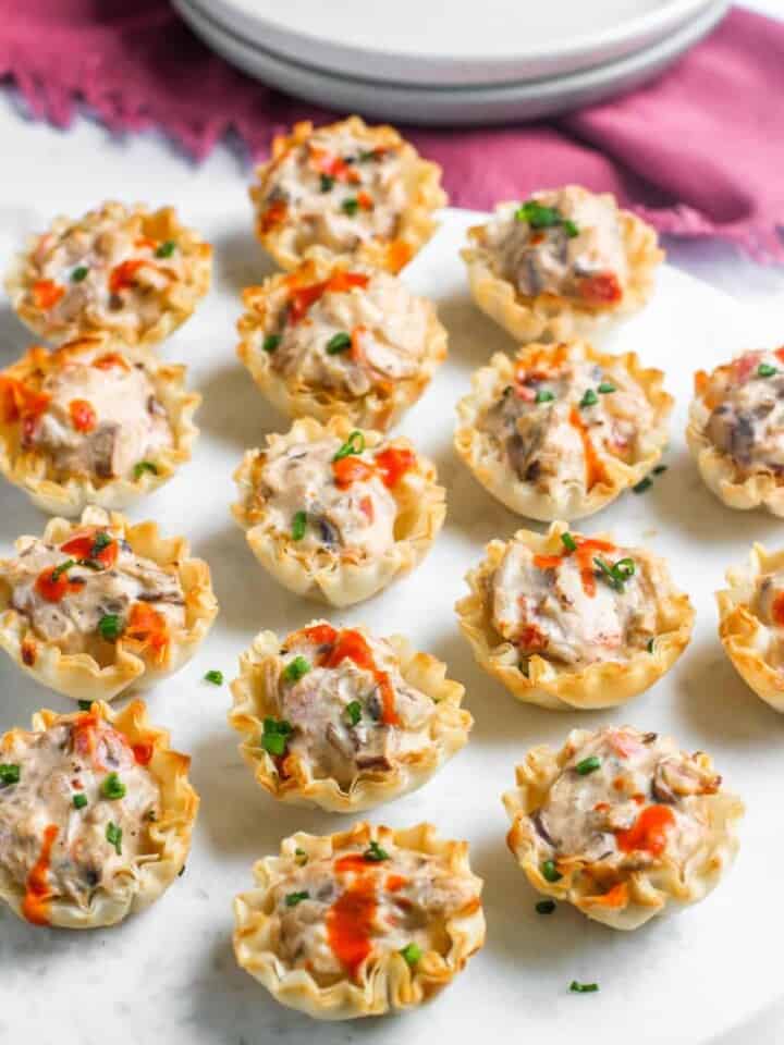 mushroom tartlets served on a marble board