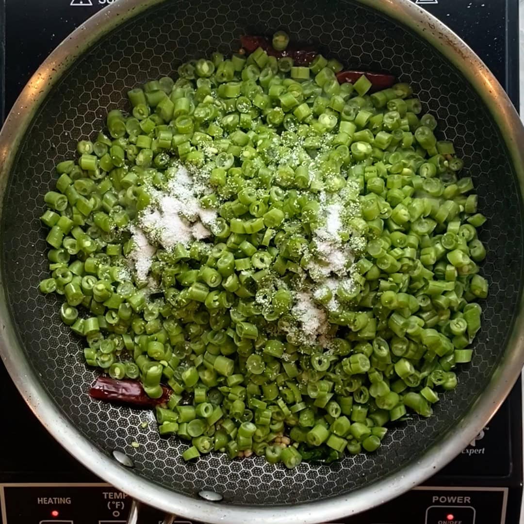 small chopped green beans and salt added to the pan.