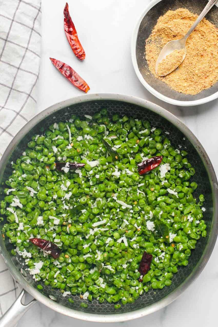 Green beans poriyal in a non stick pan with masala garnish