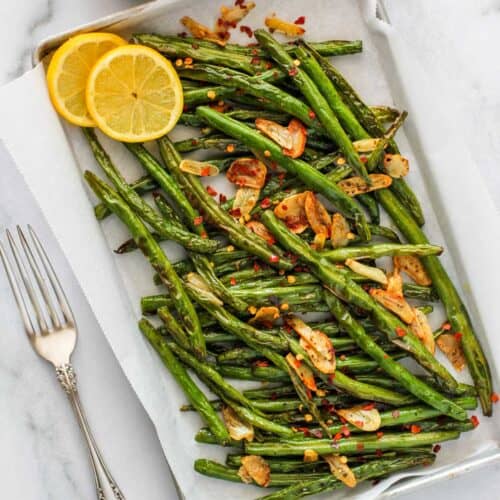 air fried green beans served with sliced lemon
