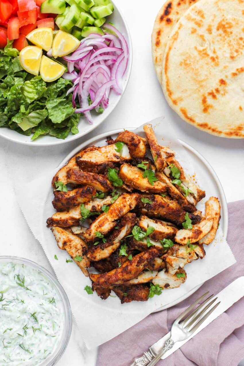 shawarma chicken served with pita bread and chopped salad 