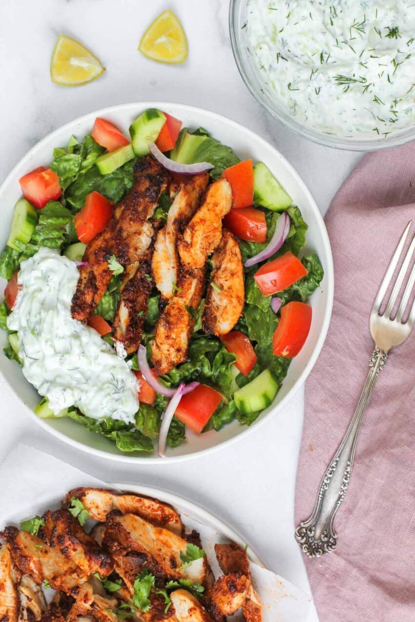 shawarma chicken served over chopped salad and tzatziki
