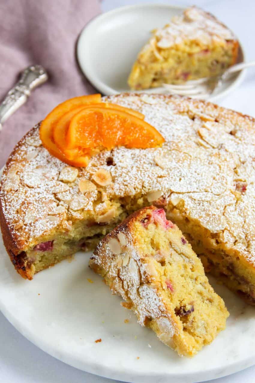 rhubarb almond cake with powdered sugar and candied orange slices 