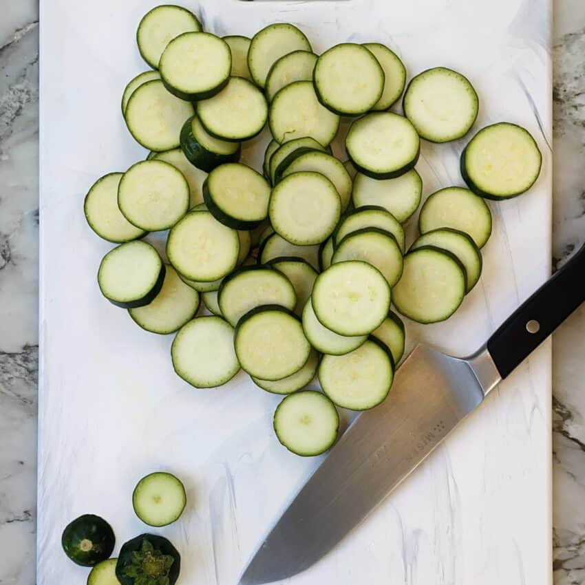 sliced zucchini on a white cutting board