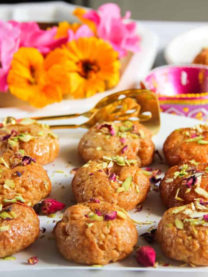 Badushah garnished with pistachios and rose petals