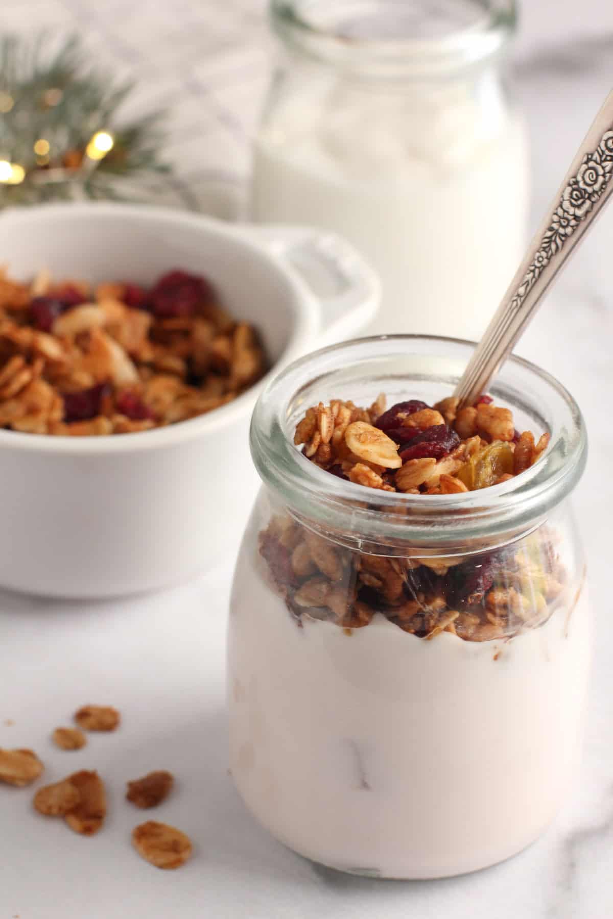 almond granola on yogurt in a glass jar 