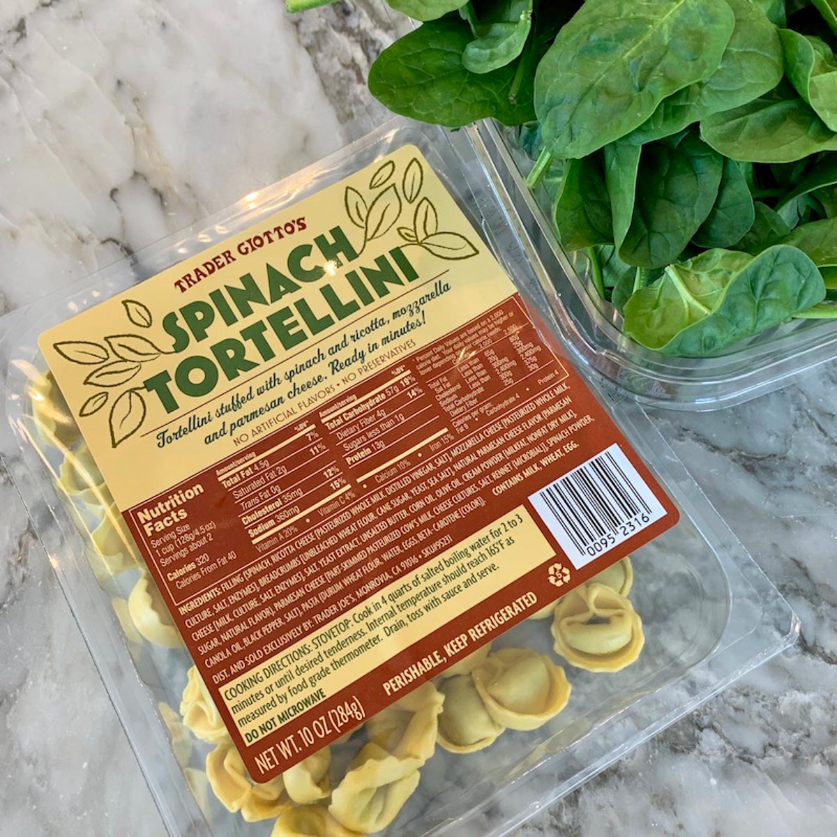 spinach tortellini and spinach on a cutting board