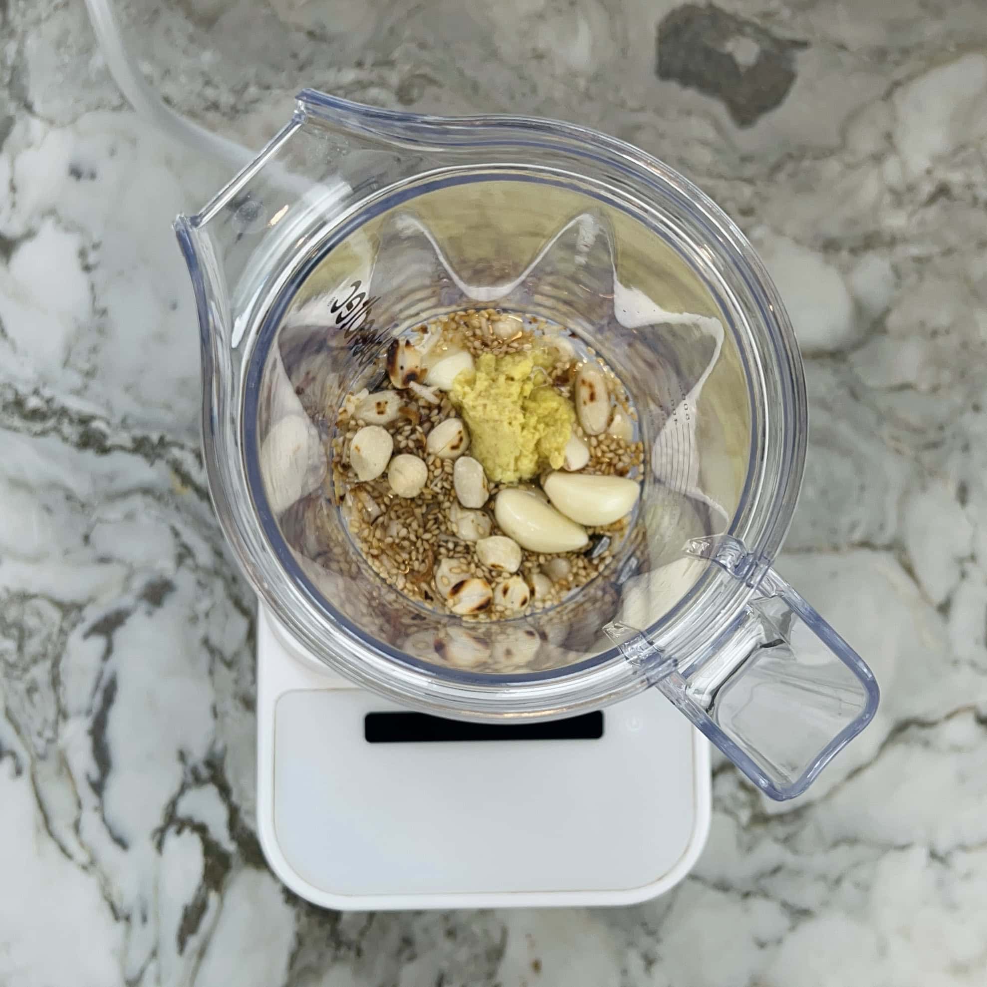 roasted sesame seeds, peanuts, ginger and garlic in a blender jar.