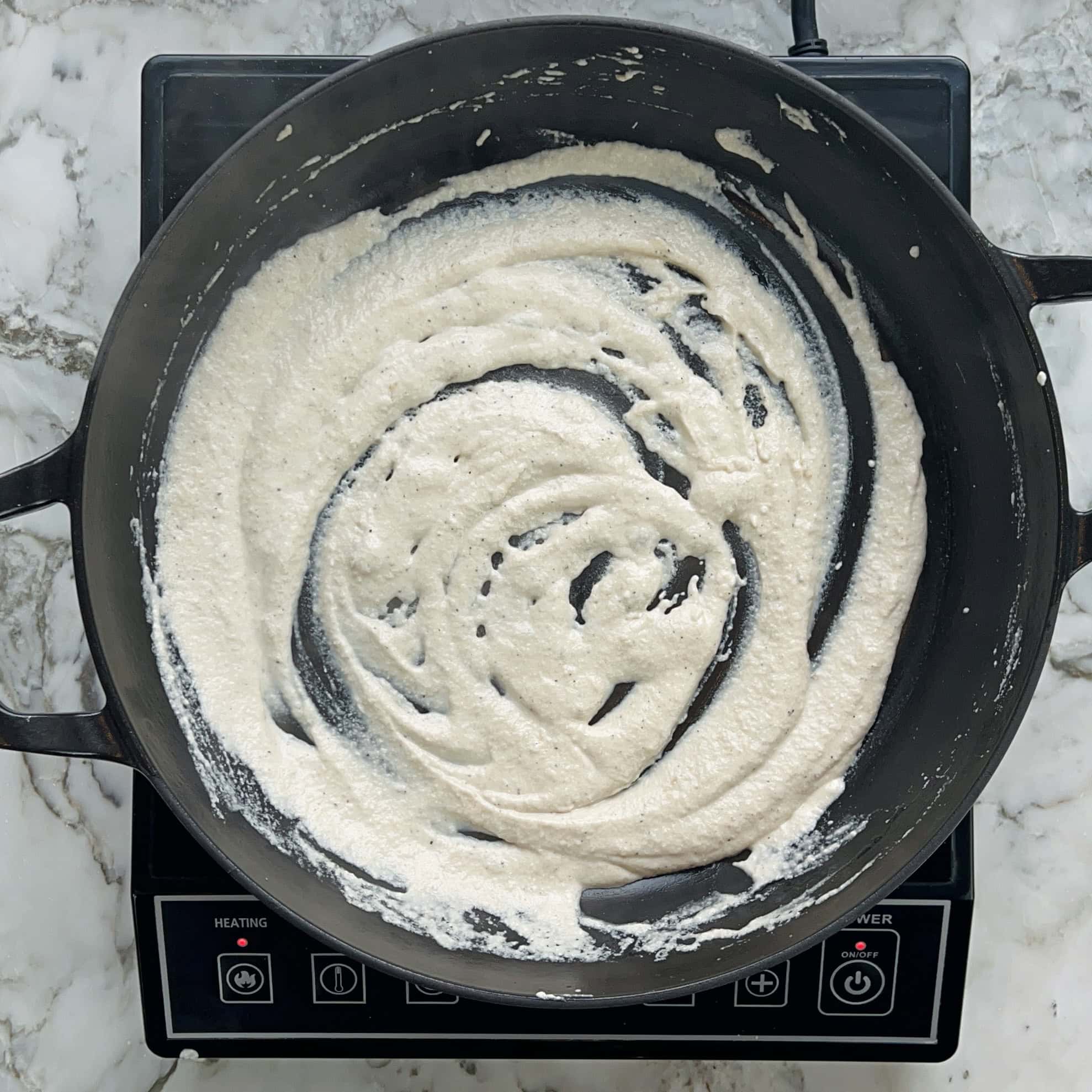 sauteeing spice paste in a pan.