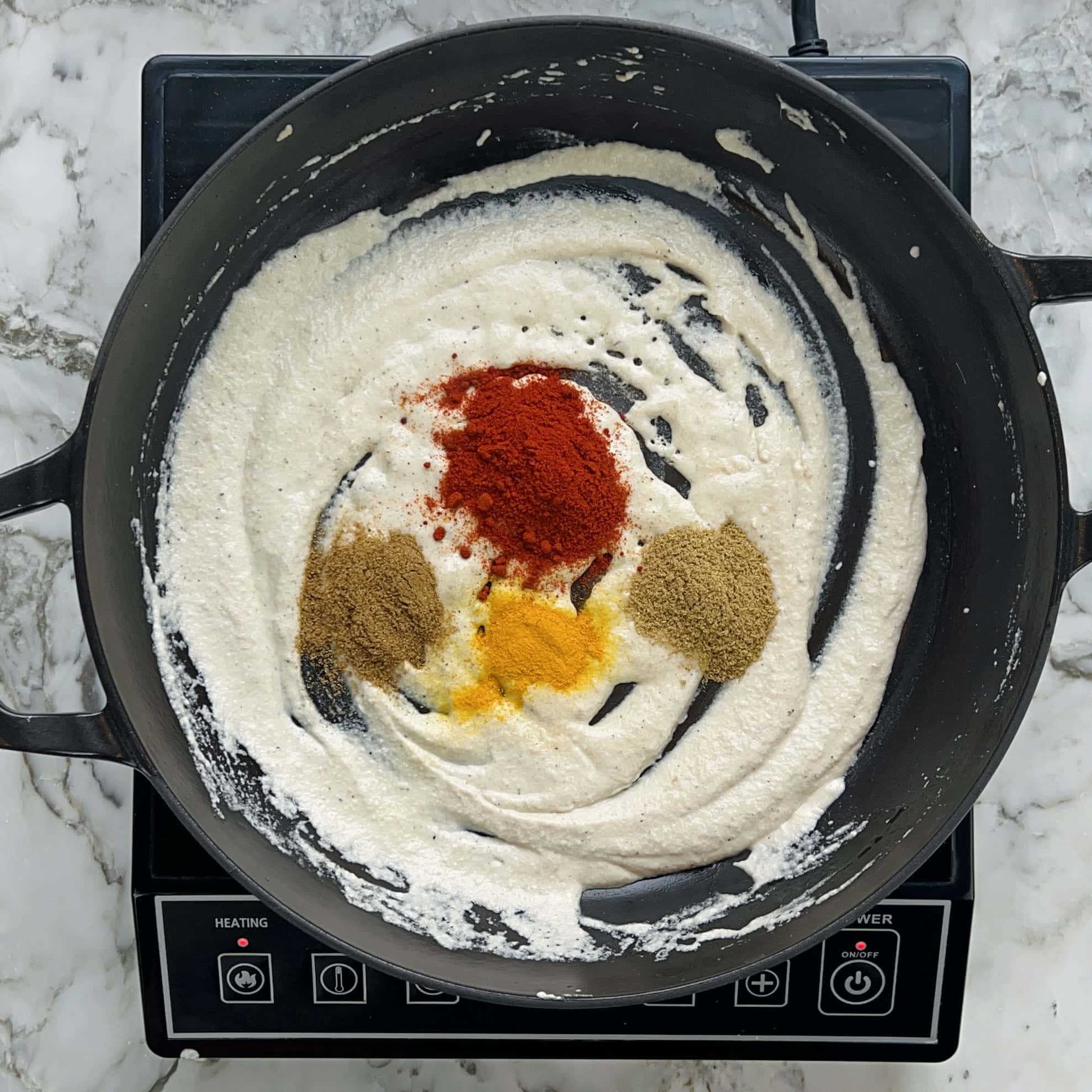 ground spices added to sauteed spice paste.