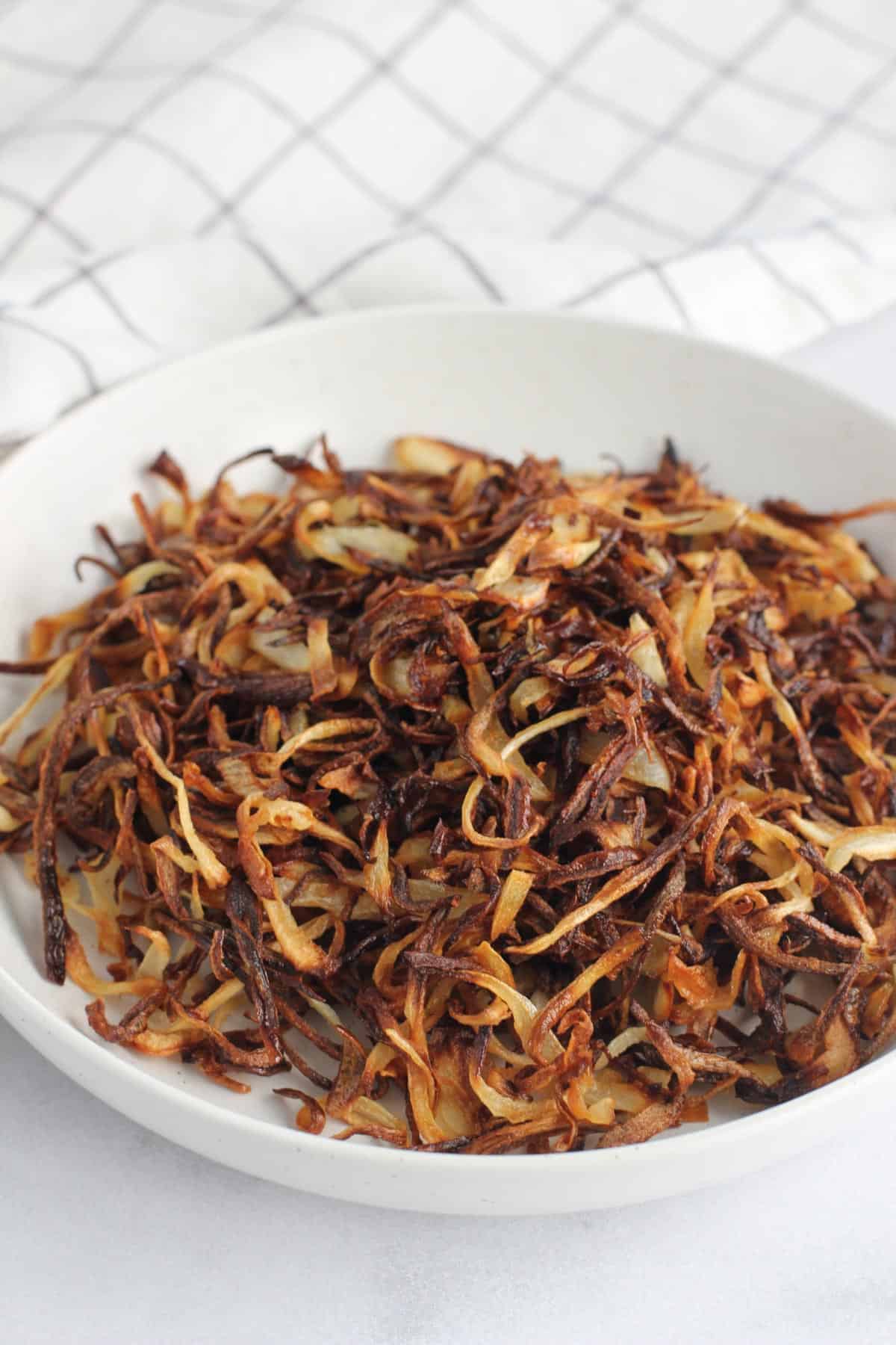 fried onions in a white bowl 