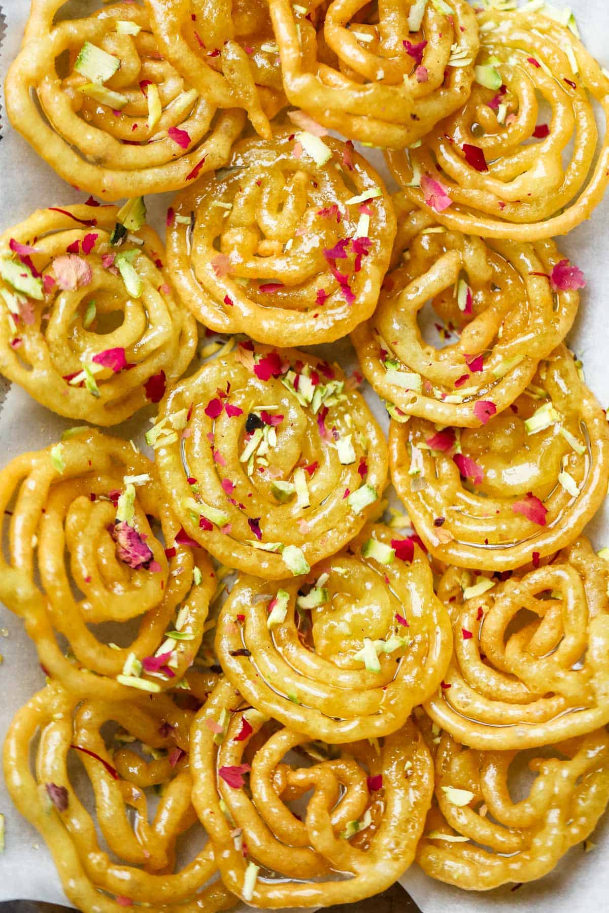 Jalebis garnished with rose petals and nuts 