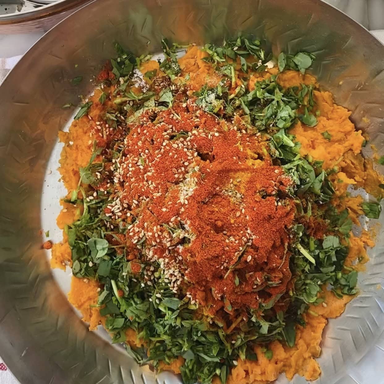 red chili powder, turmeric added to the bowl with other ingredients for thepla 