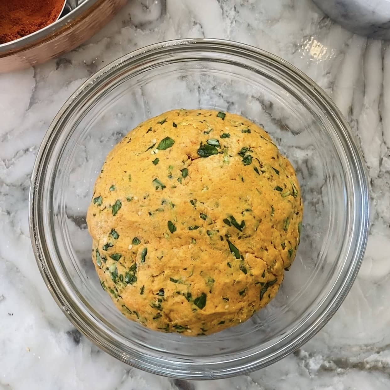 methi thepla dough in a glass bowl.