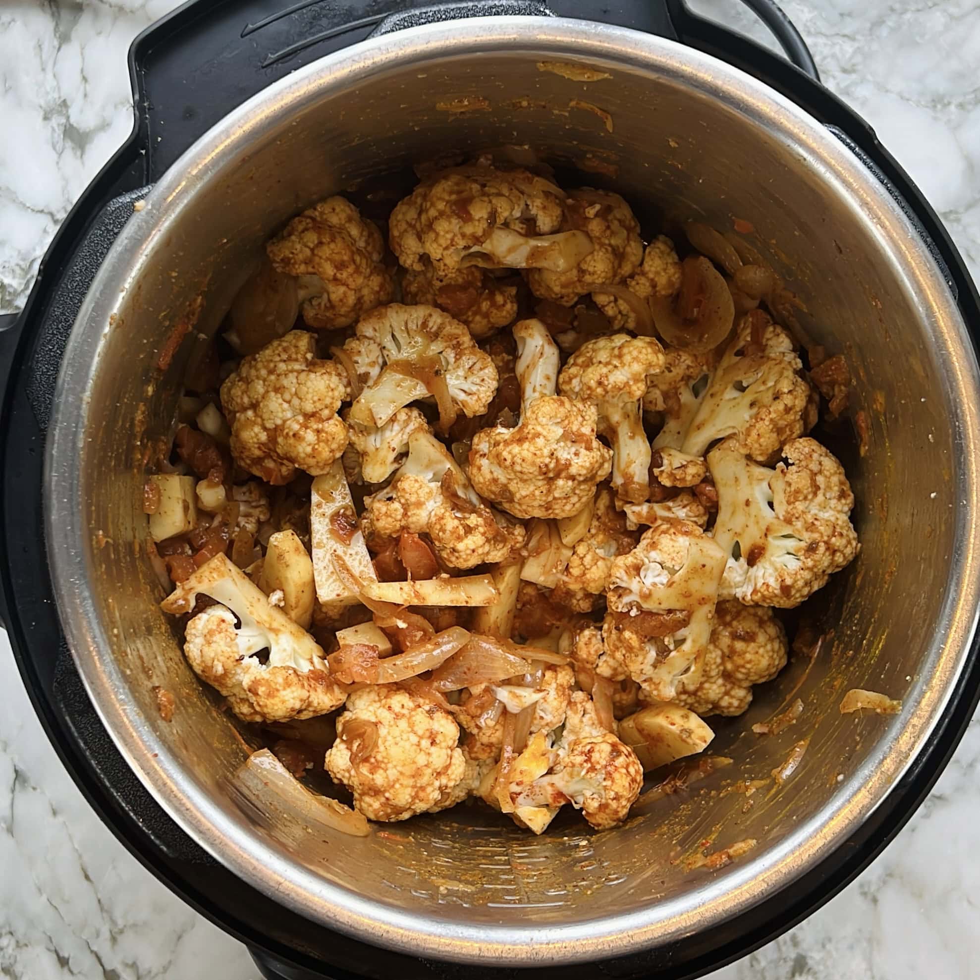 cauliflower and potatoes added to the Instant Pot.
