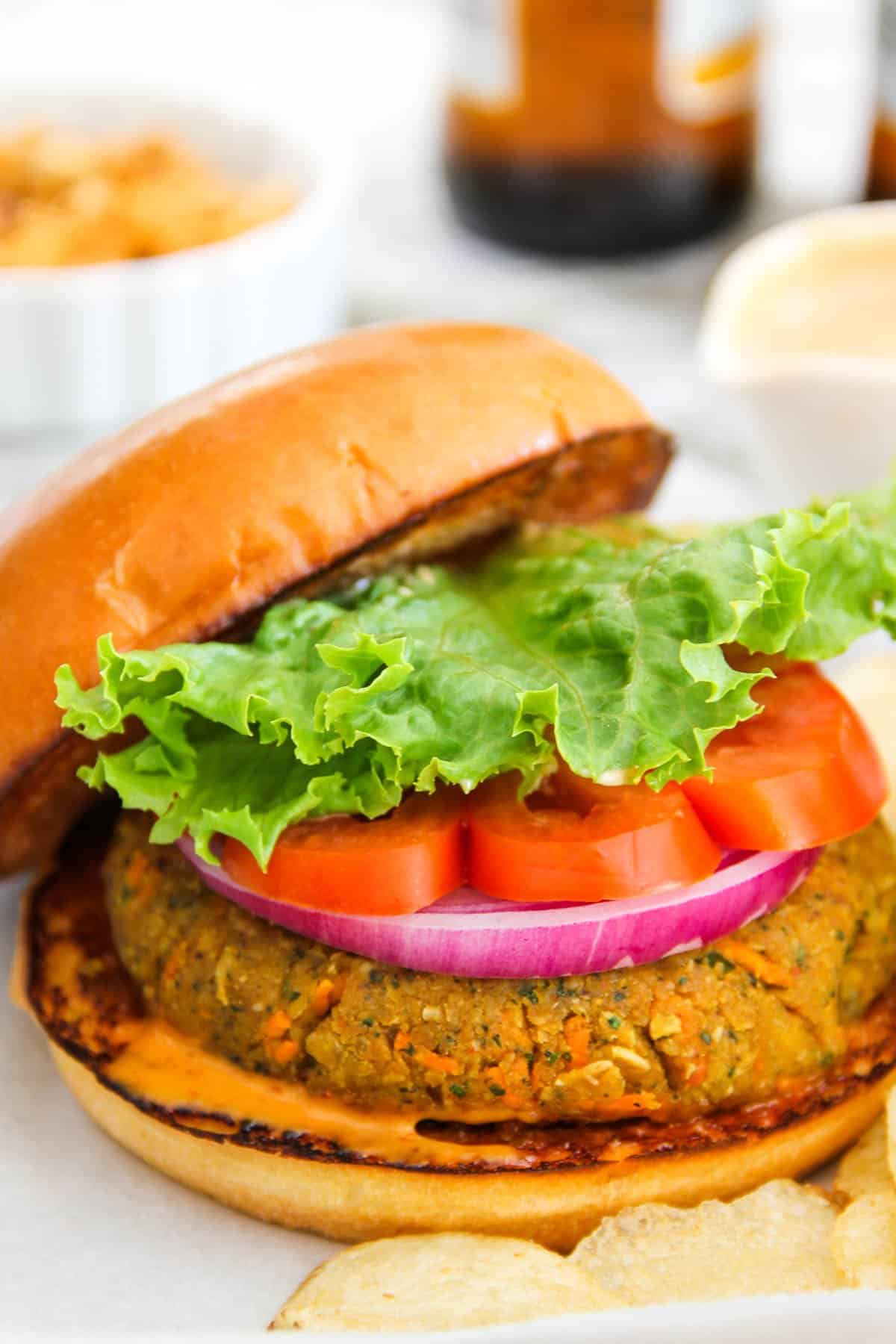 Masala chickpea burger served on a brioche bun topped with onion, tomato and lettuce 