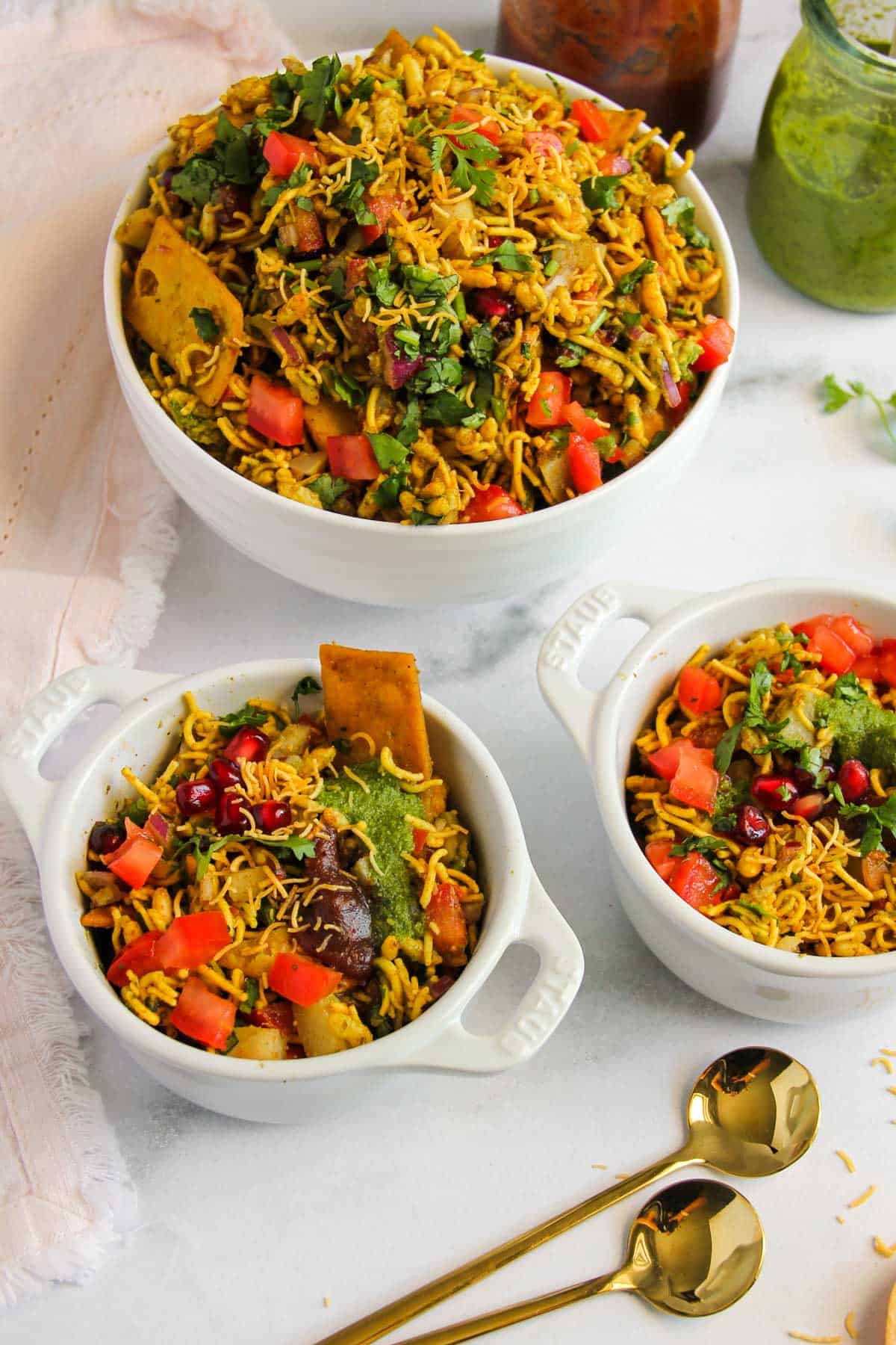 Bhel Puri in a serving bowl and two individual bowls 