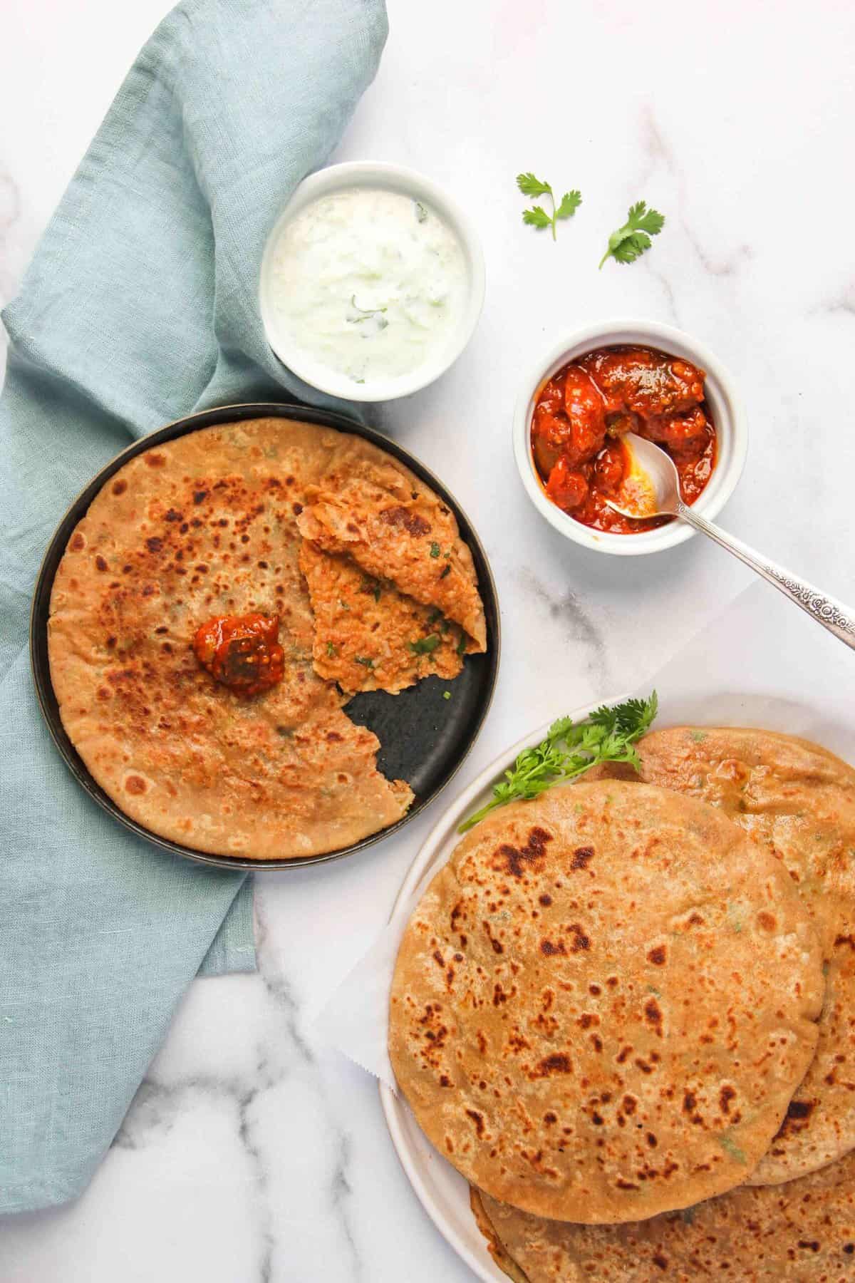 Aloo parathas served with pickled and cucumber raita 