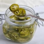 pickled jalapeños in a glass jar
