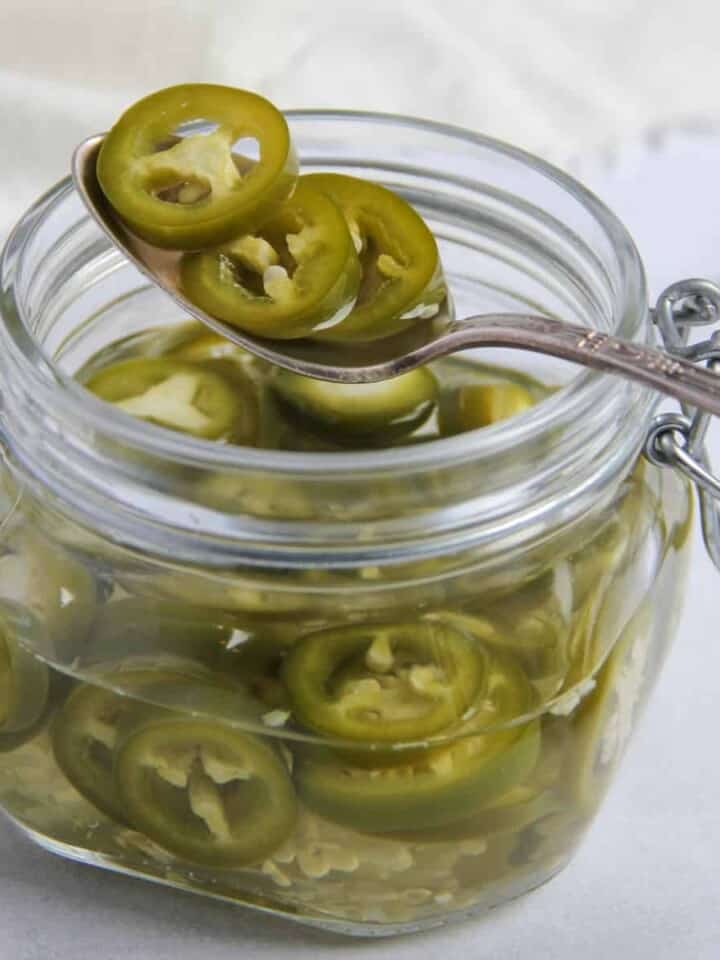 pickled jalapeños in a glass jar