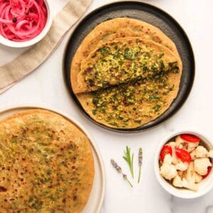 palak paneer parathas served with pickled onions and cauliflower
