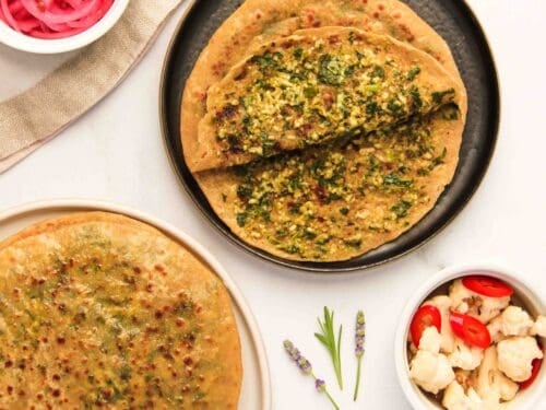 palak paneer parathas served with pickled onions and cauliflower