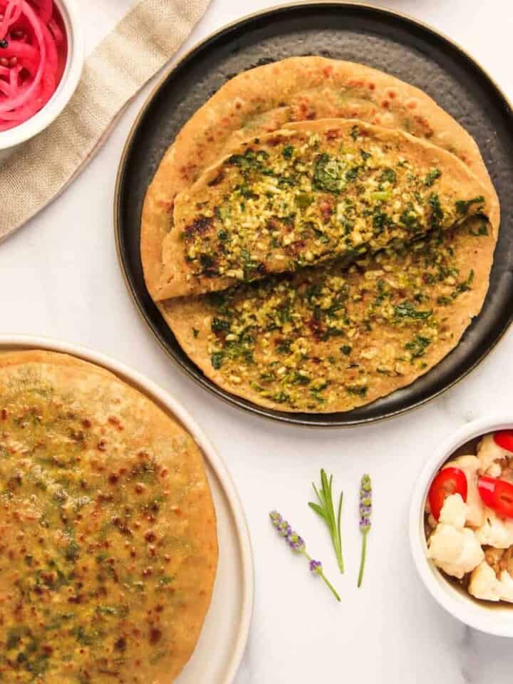 palak paneer parathas served with pickled onions and cauliflower