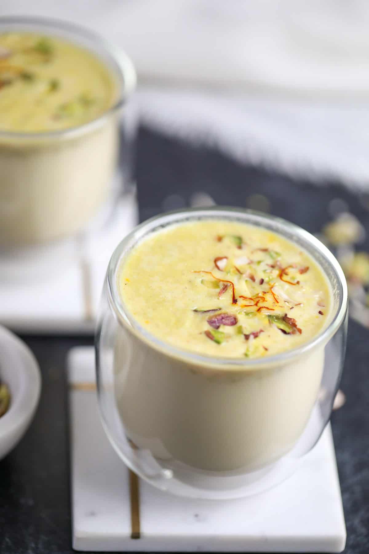 masala doodh garnished with pistachios and saffron 