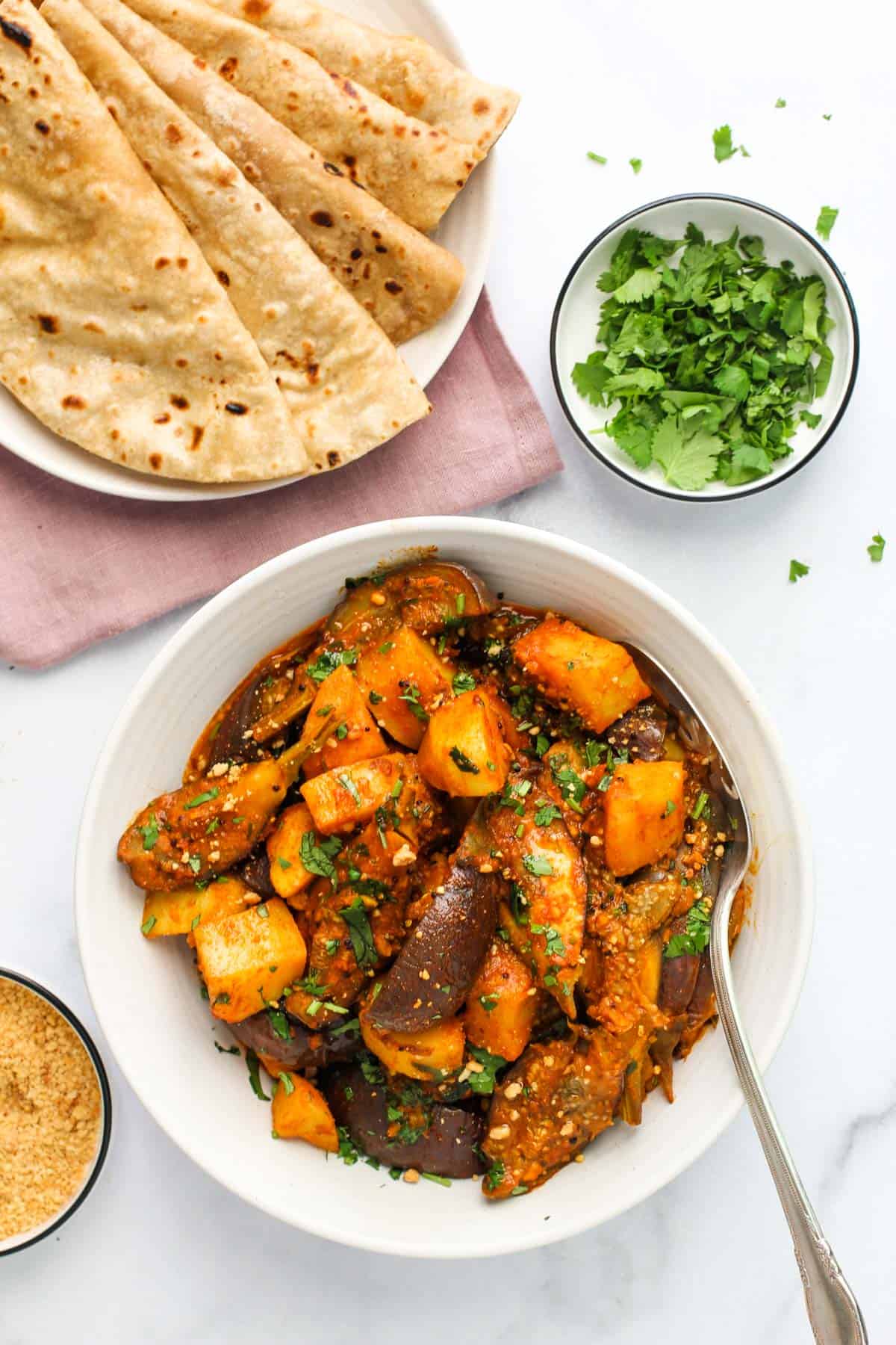 curried eggplant and potatoes  served with roti 