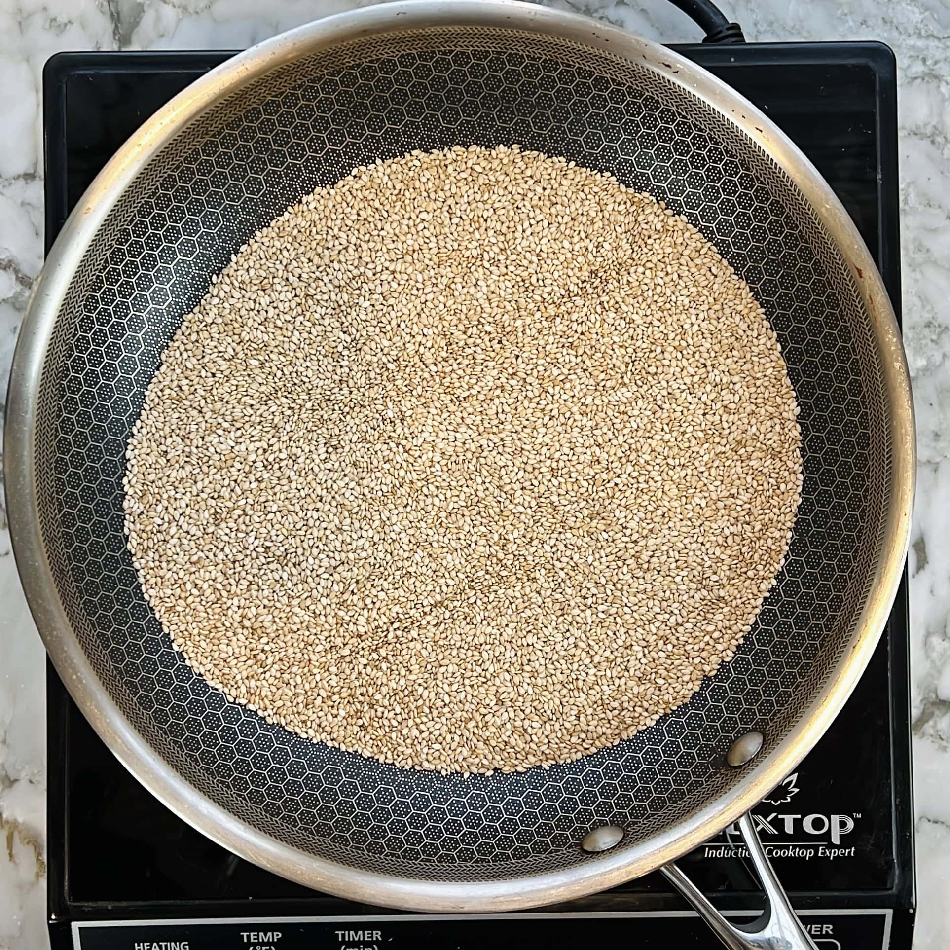 Roasting sesame seeds in a nonstick pan.