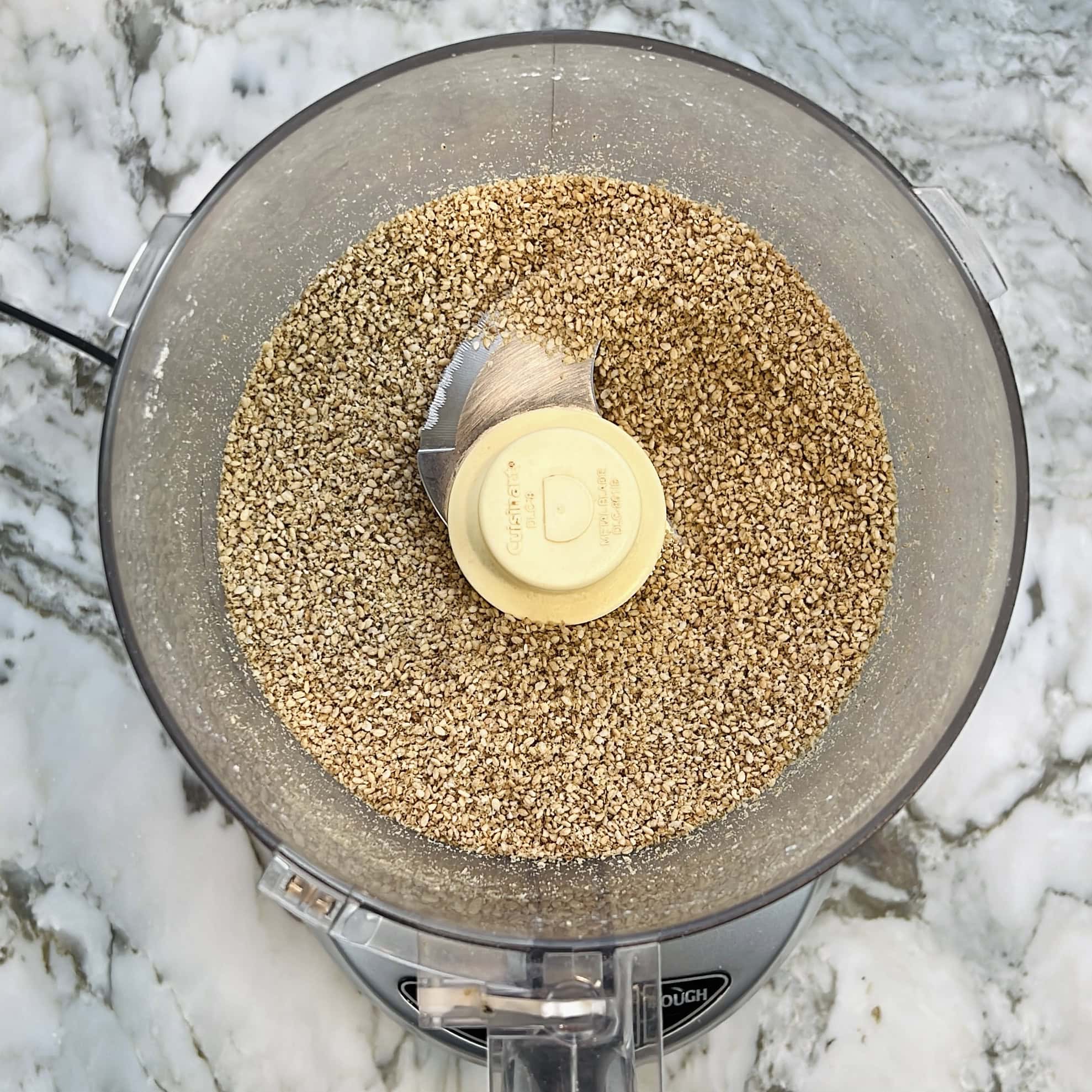 grinding roasted sesame seeds in a food processor to make coarse powder.