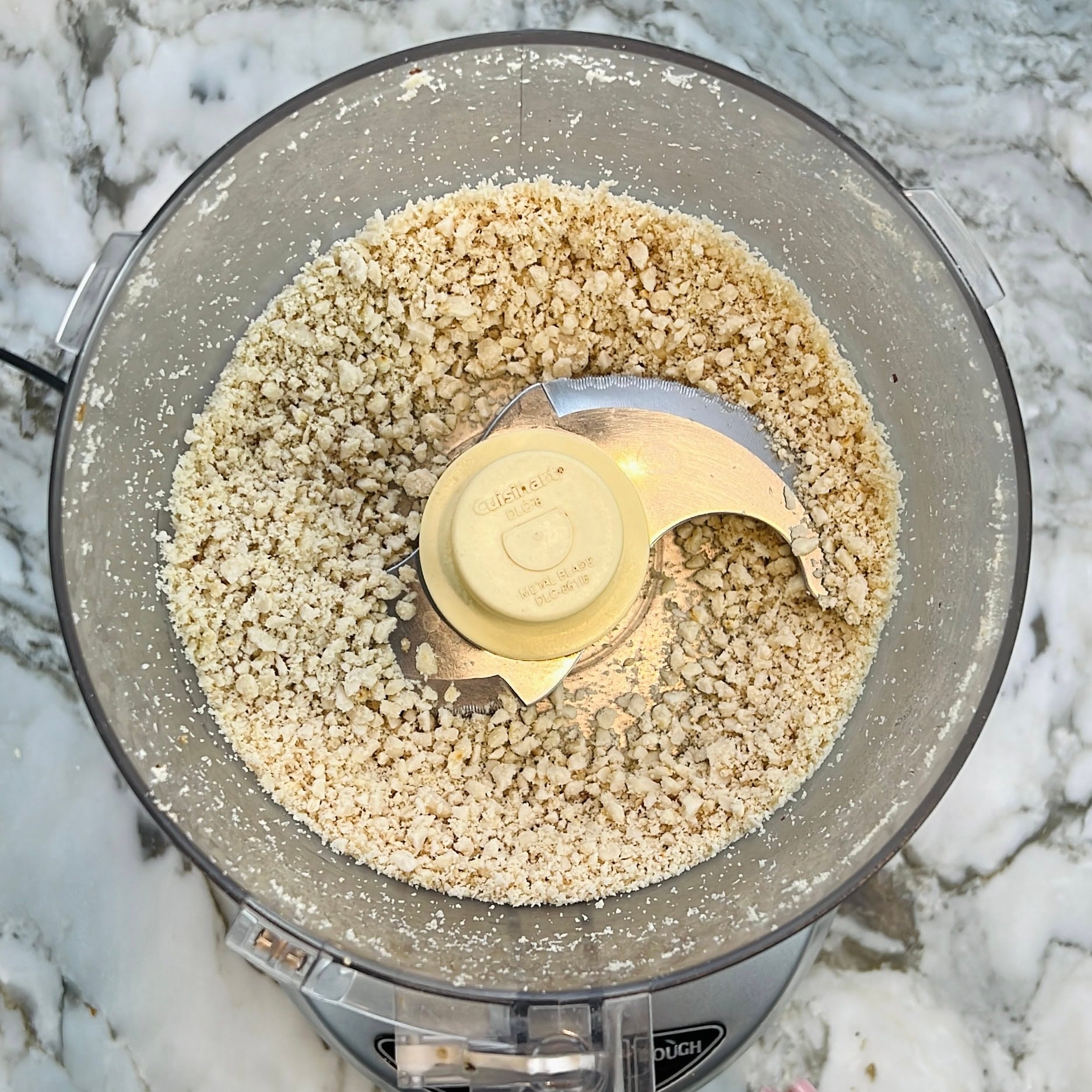 coarsely ground peanuts in a food processor jar.