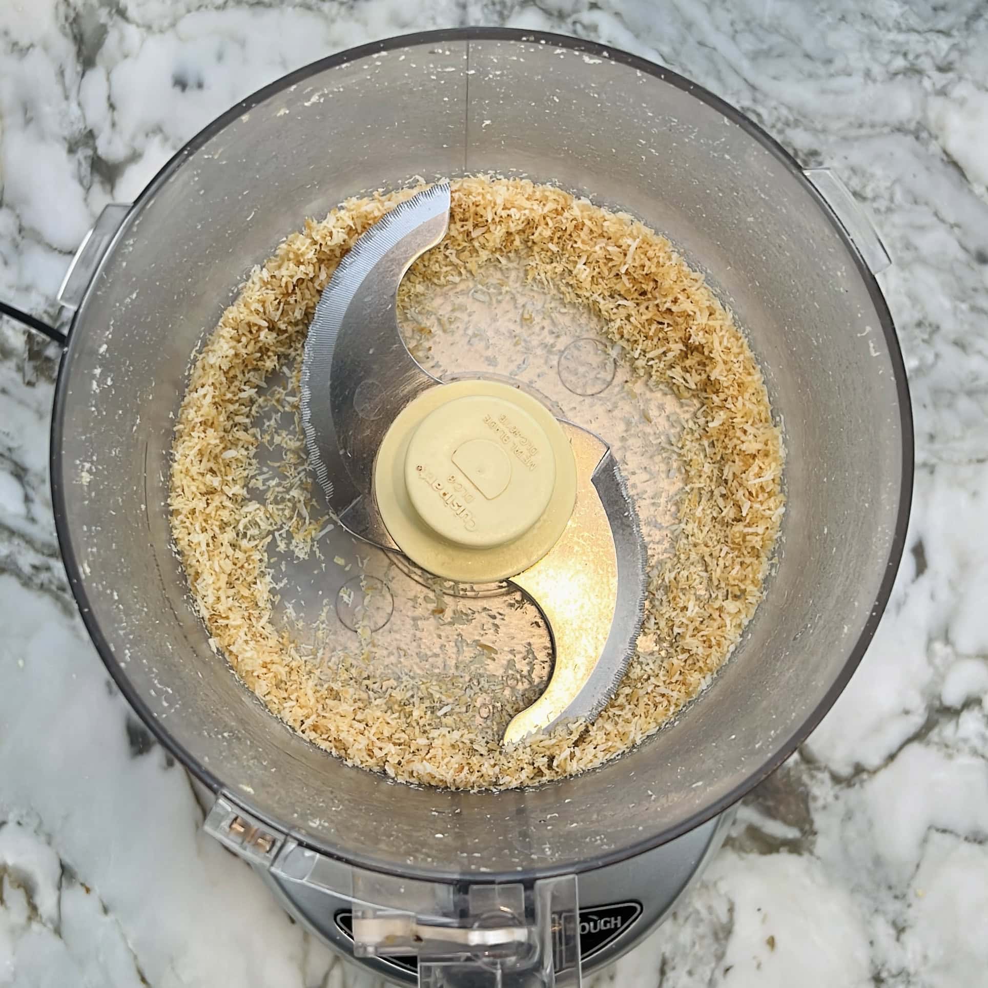 coarsely ground coconut in a food processor jar.